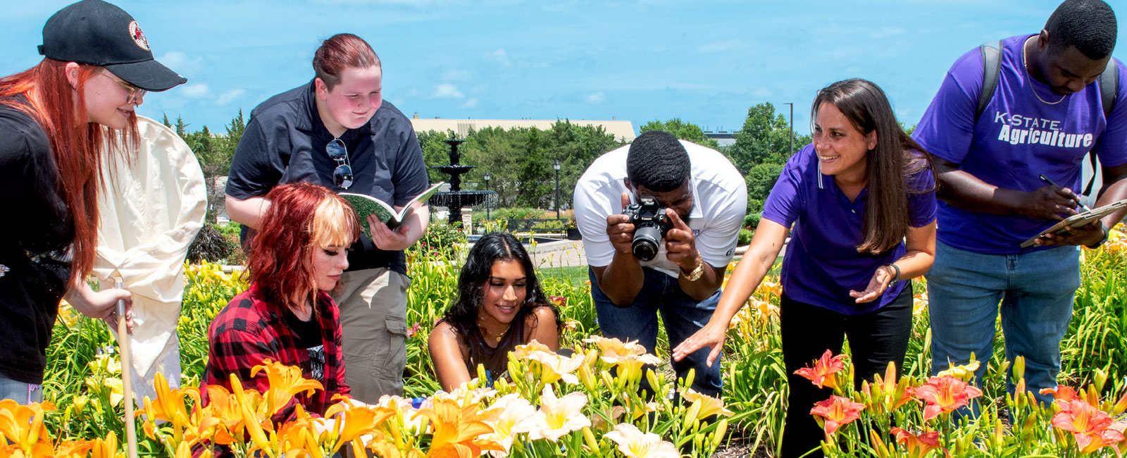 student with instructor outside sampling bugs in flowers